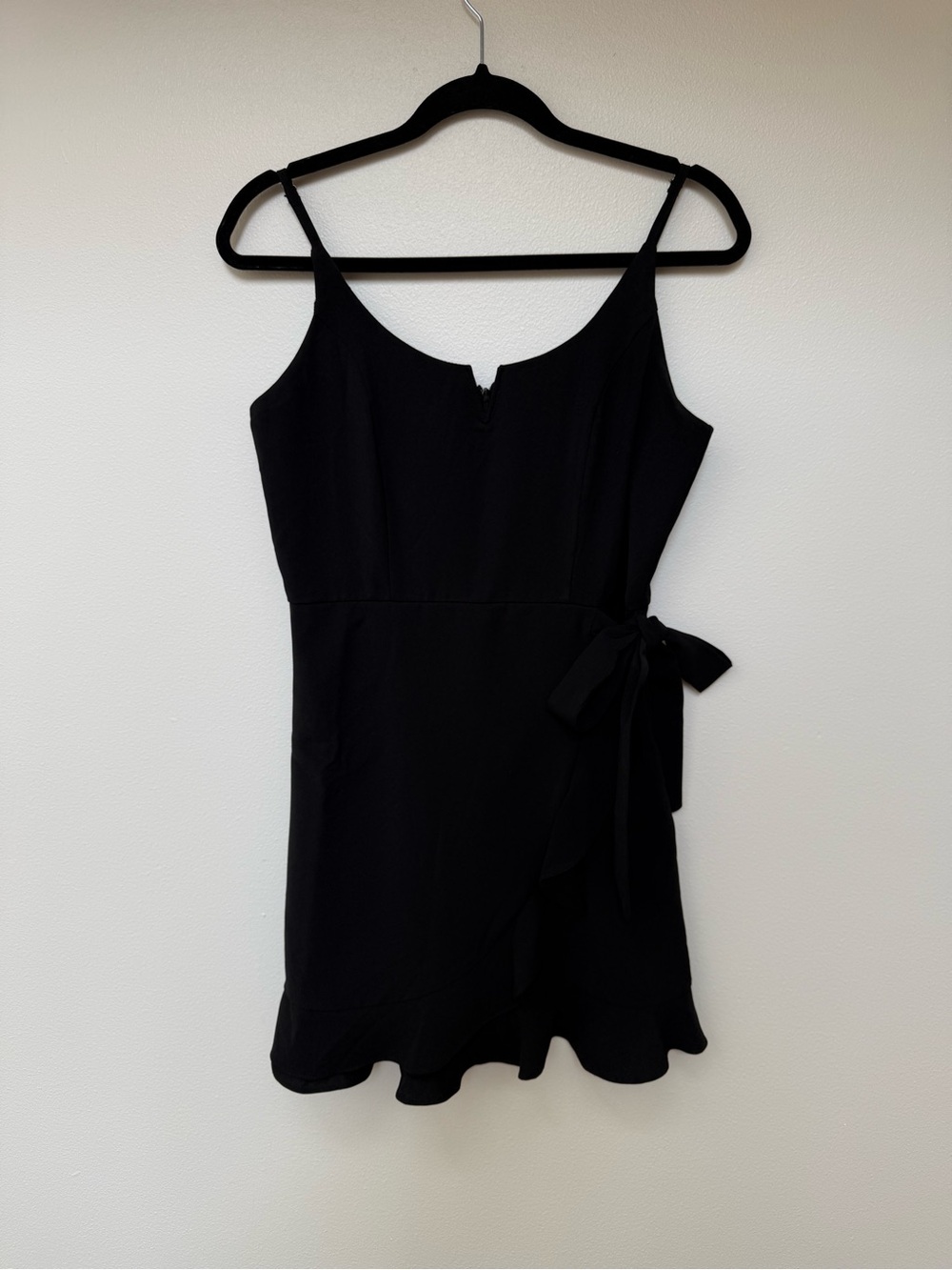 Black mini dress with wrap tie and ruffle trim